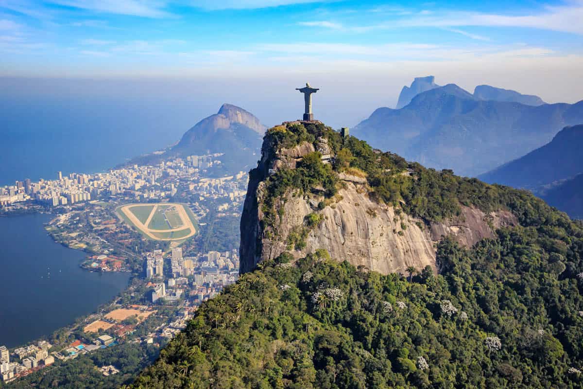 Christ the Redeemer stands on forested Corcovado Mountain above Rio de Janeiro, Brazil.