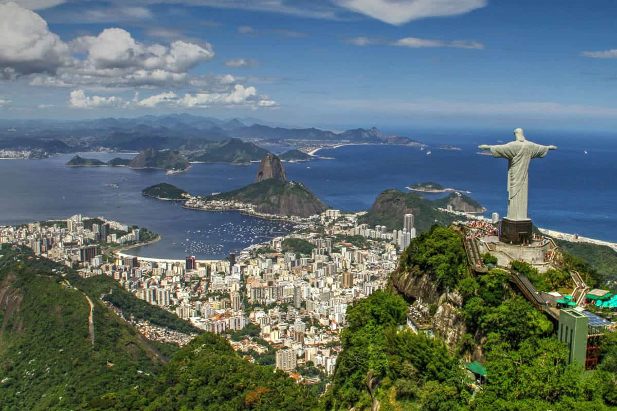Christ the Redeemer rises over central Rio de Janeiro, Brazil, with Sugarloaf Mountain beyond.